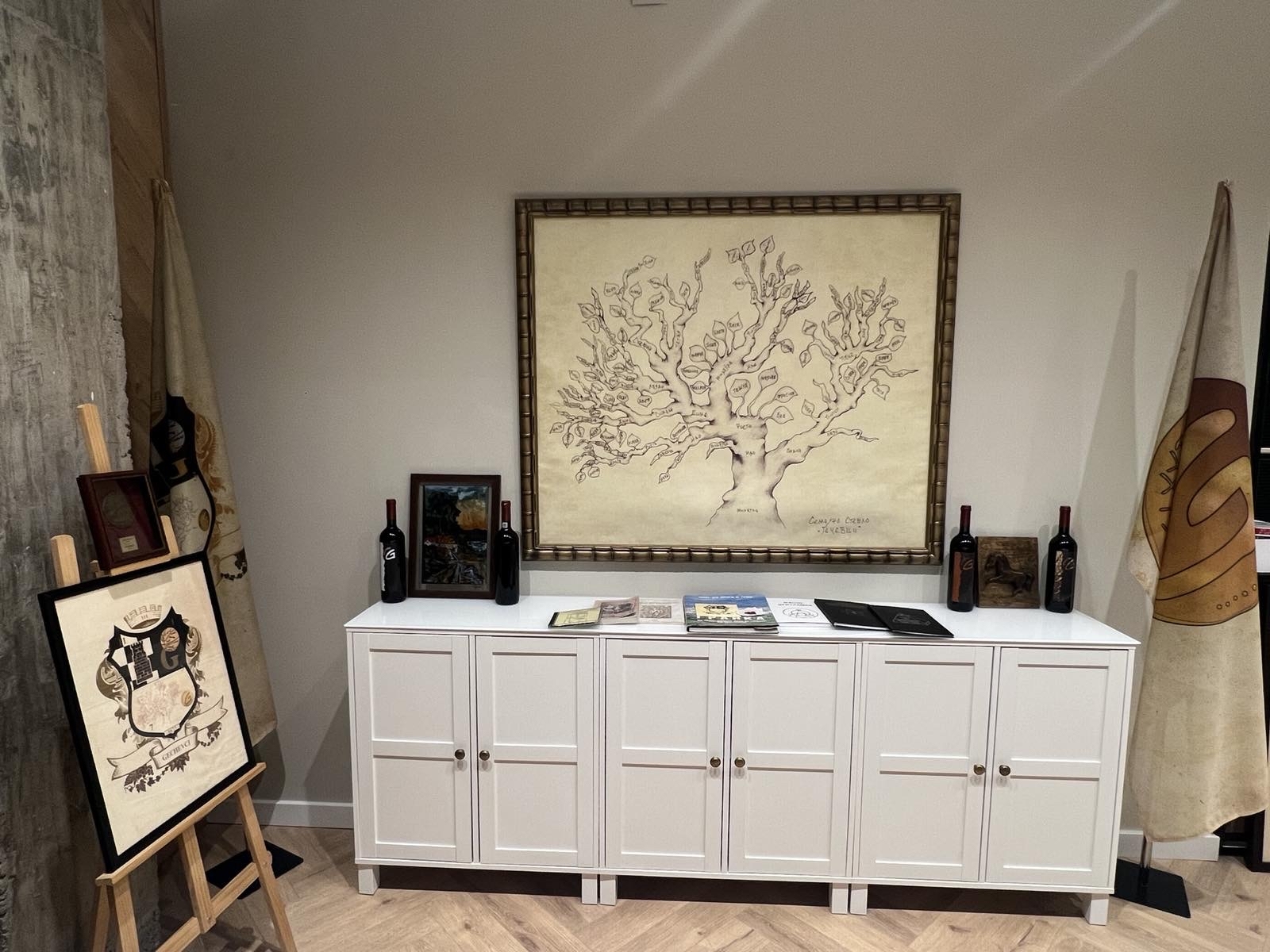 Wine room display with bottles, artwork, and regional presentation material