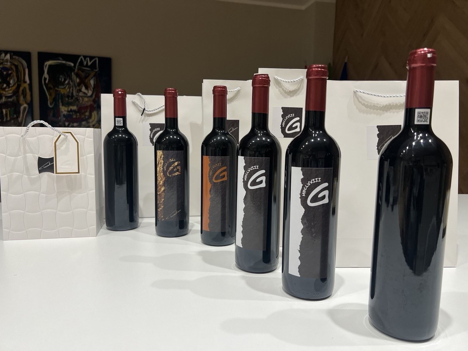 Premium Cabernet Sauvignon bottle among wine gift bags