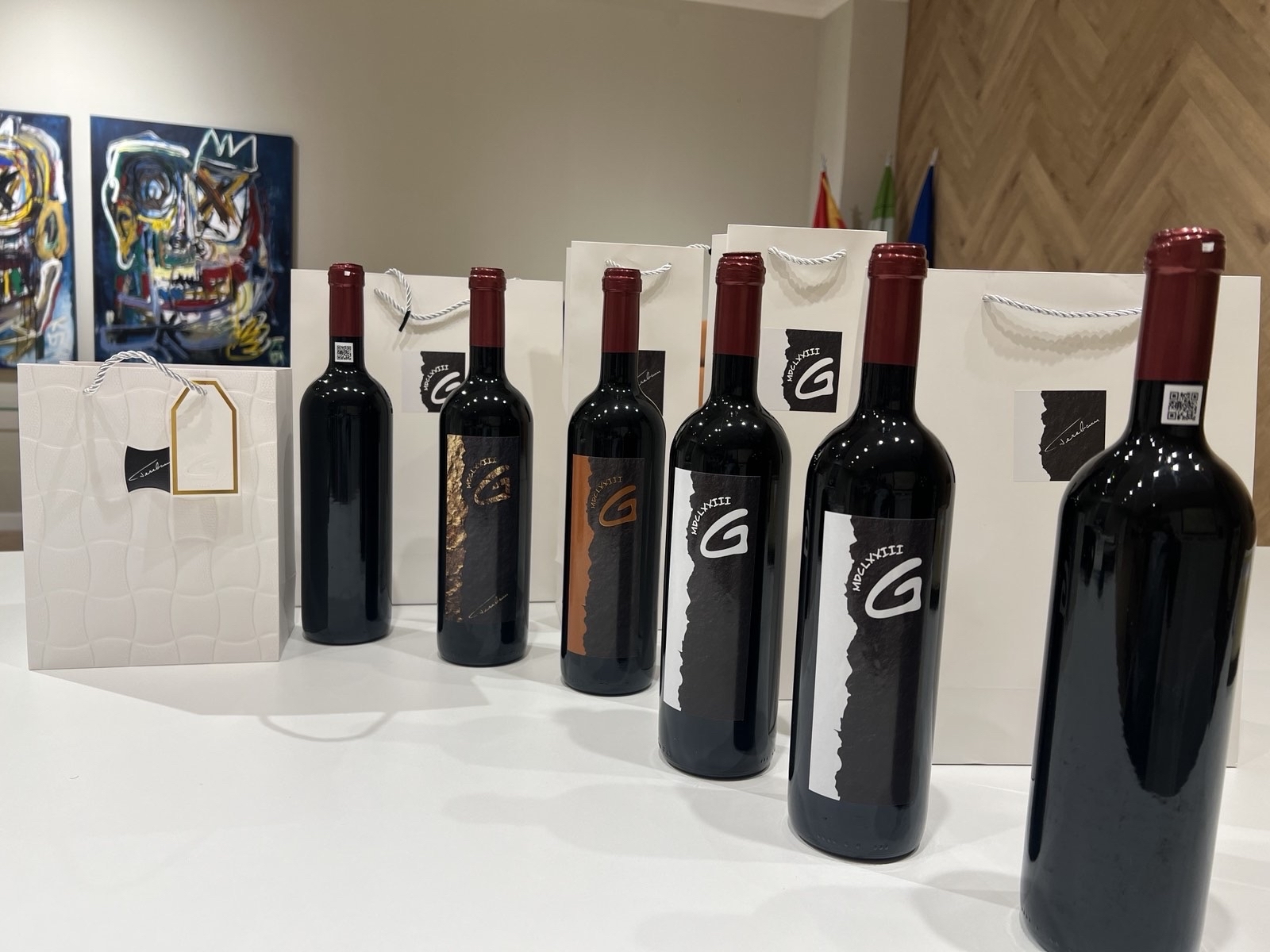 Premium red wine bottles presented with elegant gift bags
